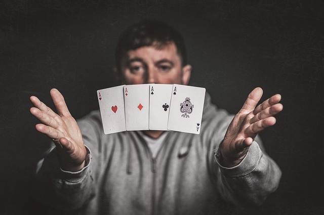 Magician holding playing cards, symbolizing strategic card play